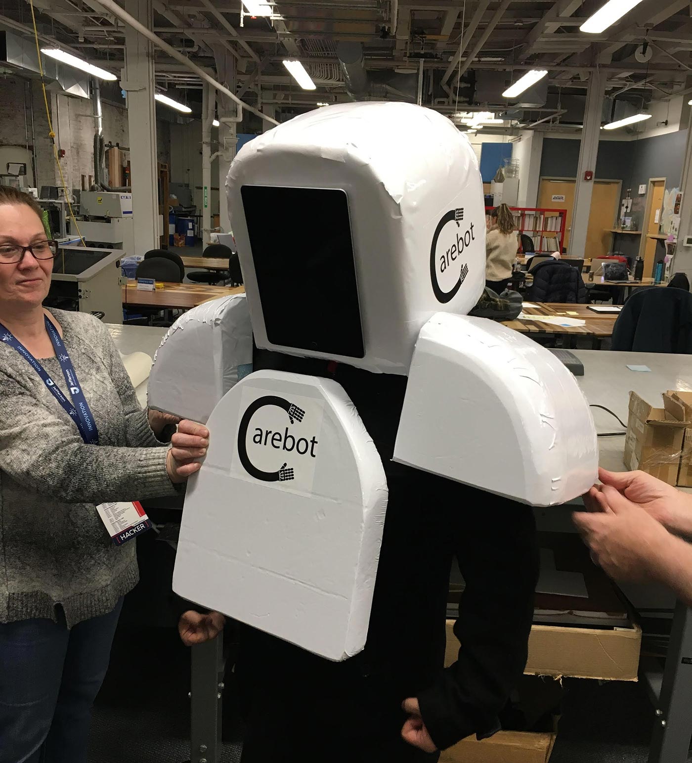 The "Reimagining Death" team try on their "Carebot" prototype.